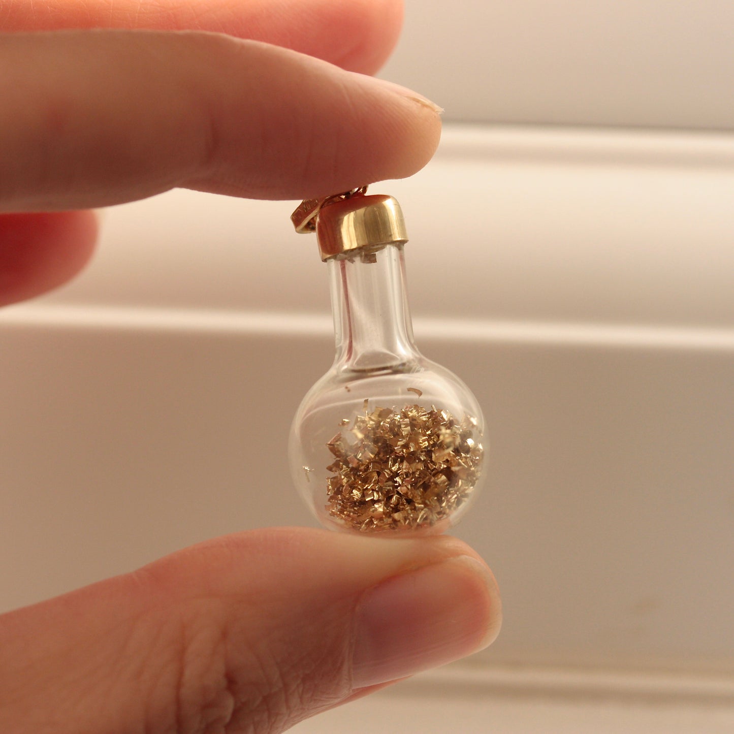 vintage bottle of gold charm