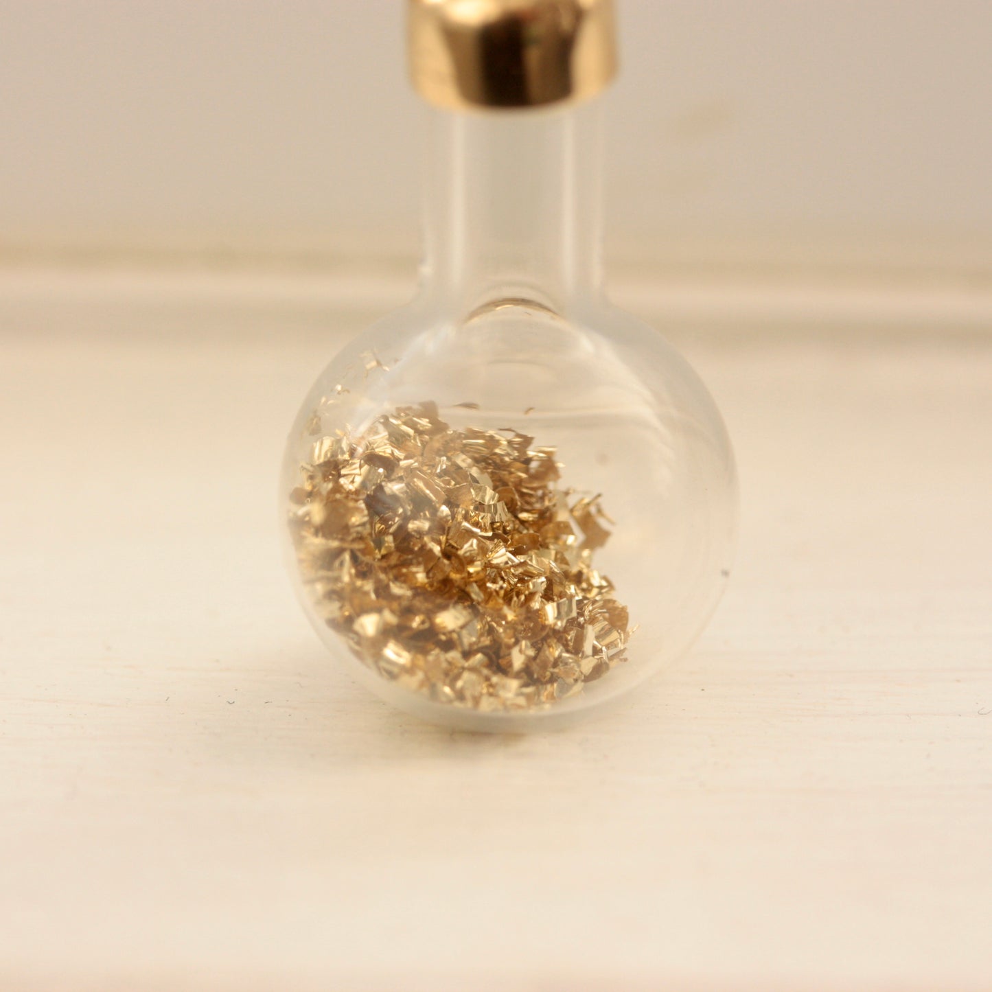 vintage bottle of gold charm