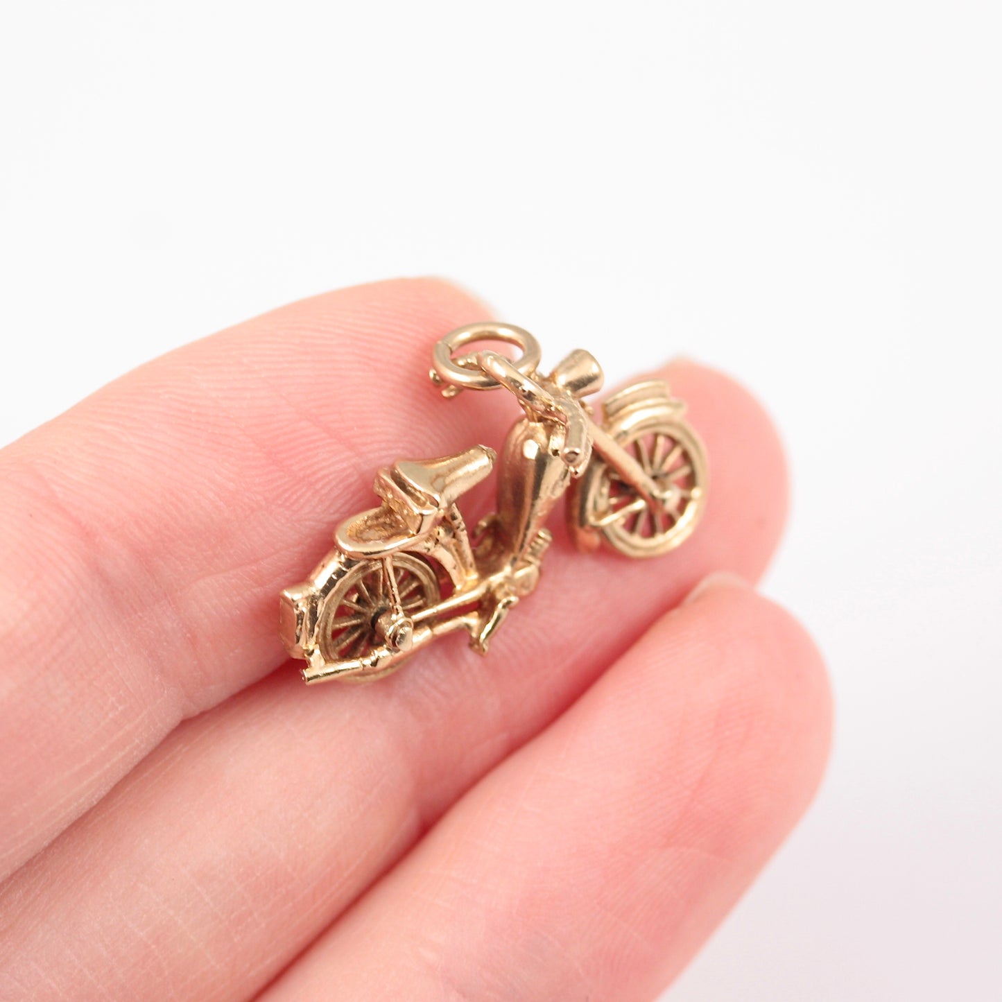 vintage 9ct gold motorbike charm with articulated wheels