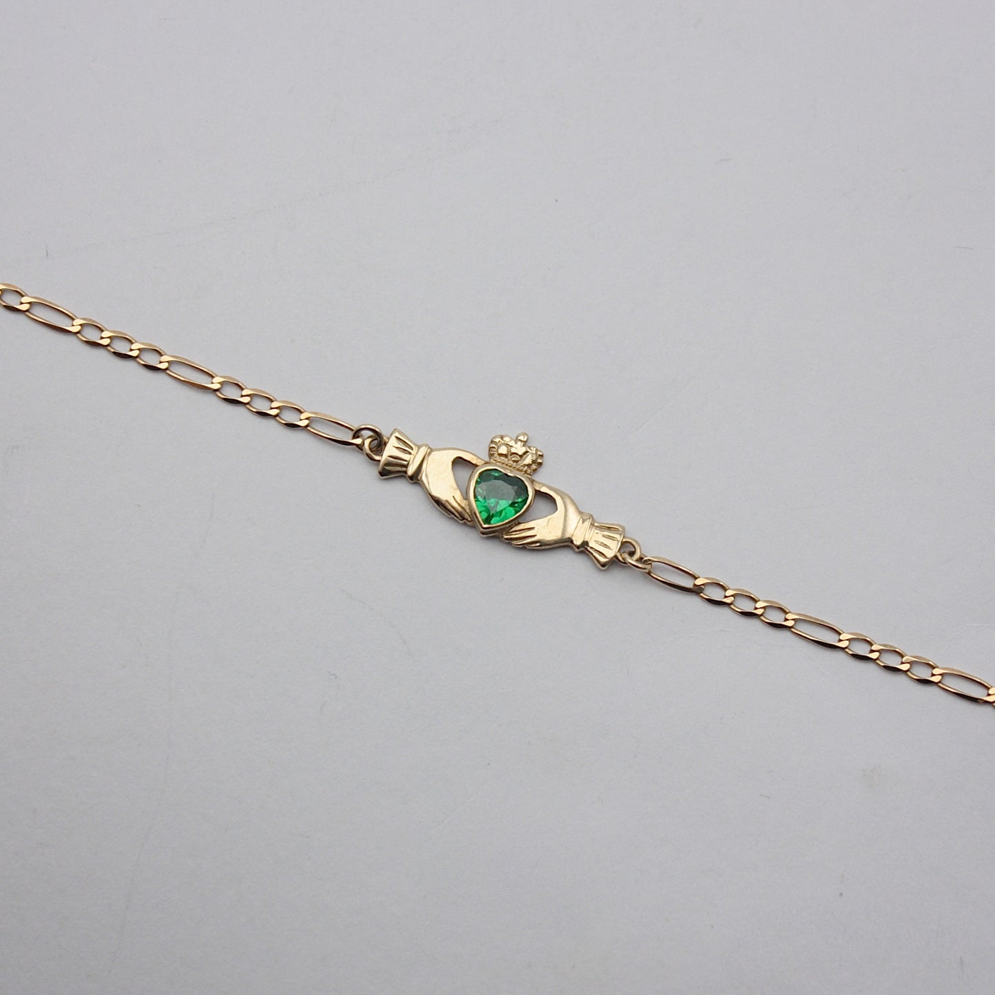 Pre-owned 9ct Gold Claddagh Figaro Bracelet with Green CZ