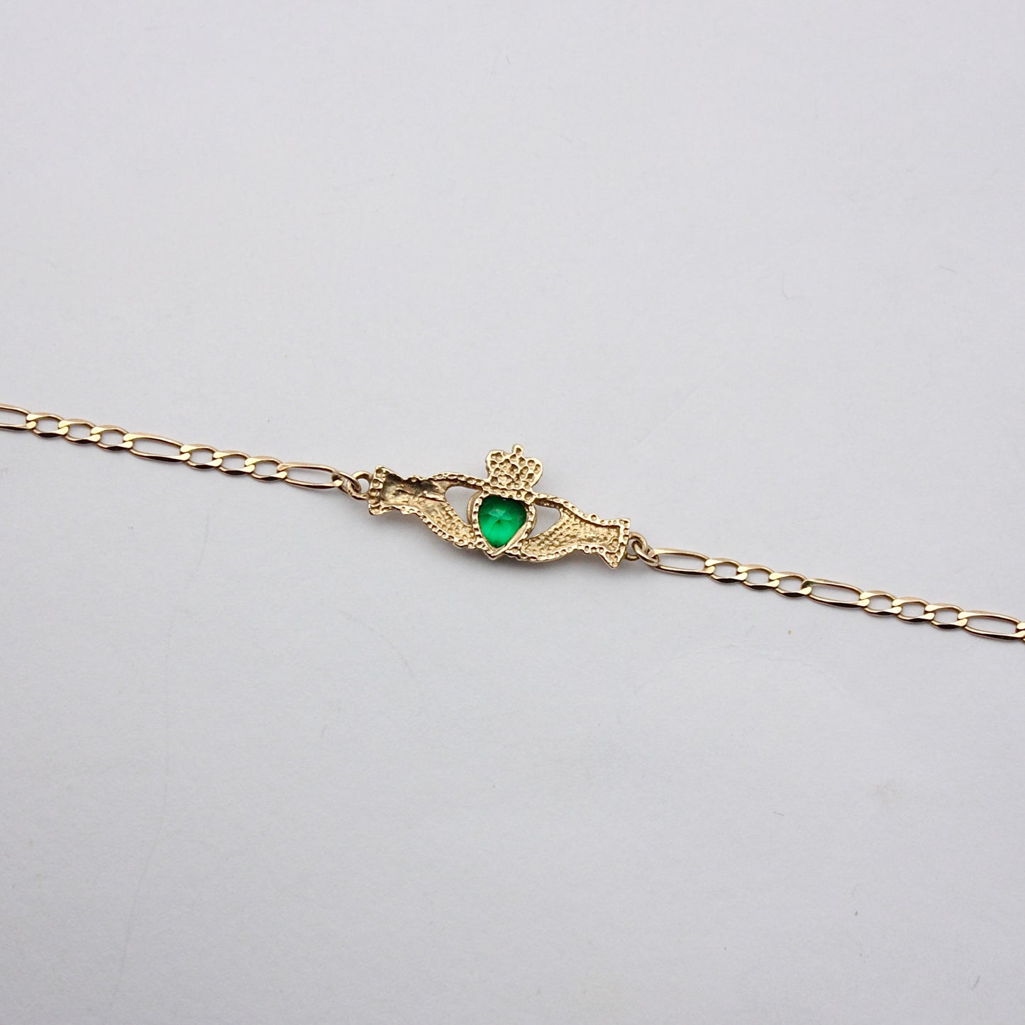 Pre-owned 9ct Gold Claddagh Figaro Bracelet with Green CZ