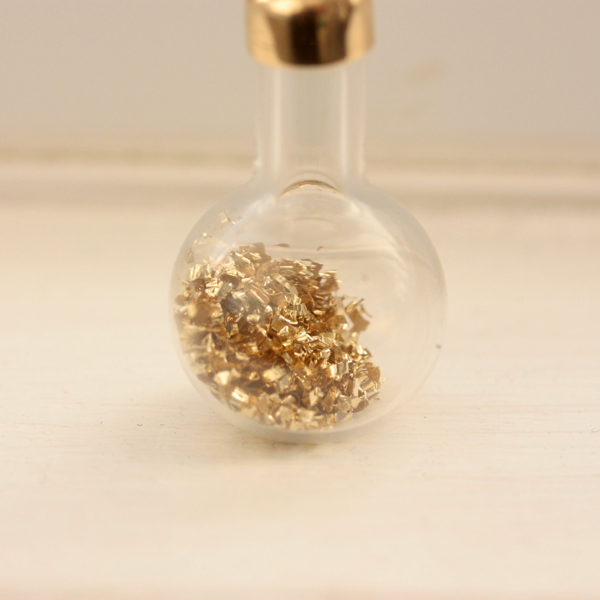 vintage bottle of gold charm