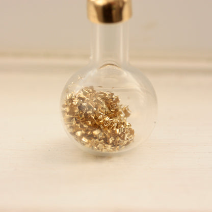 vintage bottle of gold charm