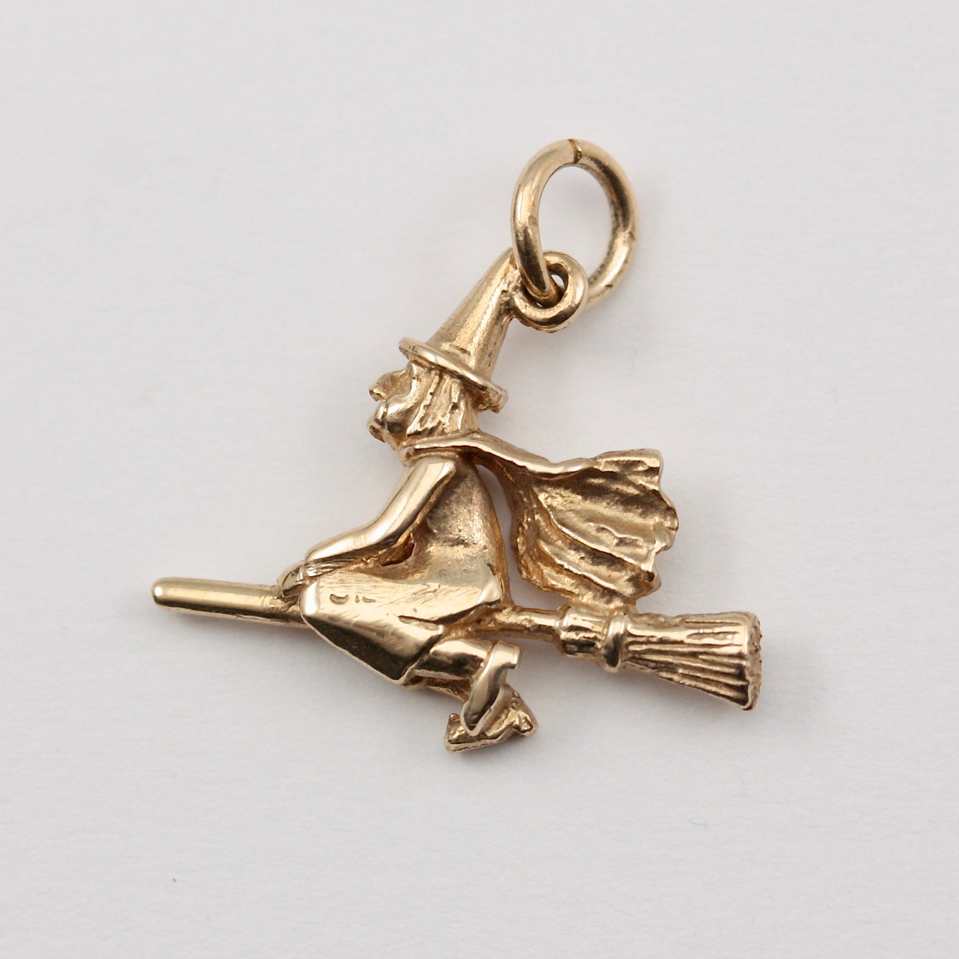 pre-owned 9ct gold witch on broom charm