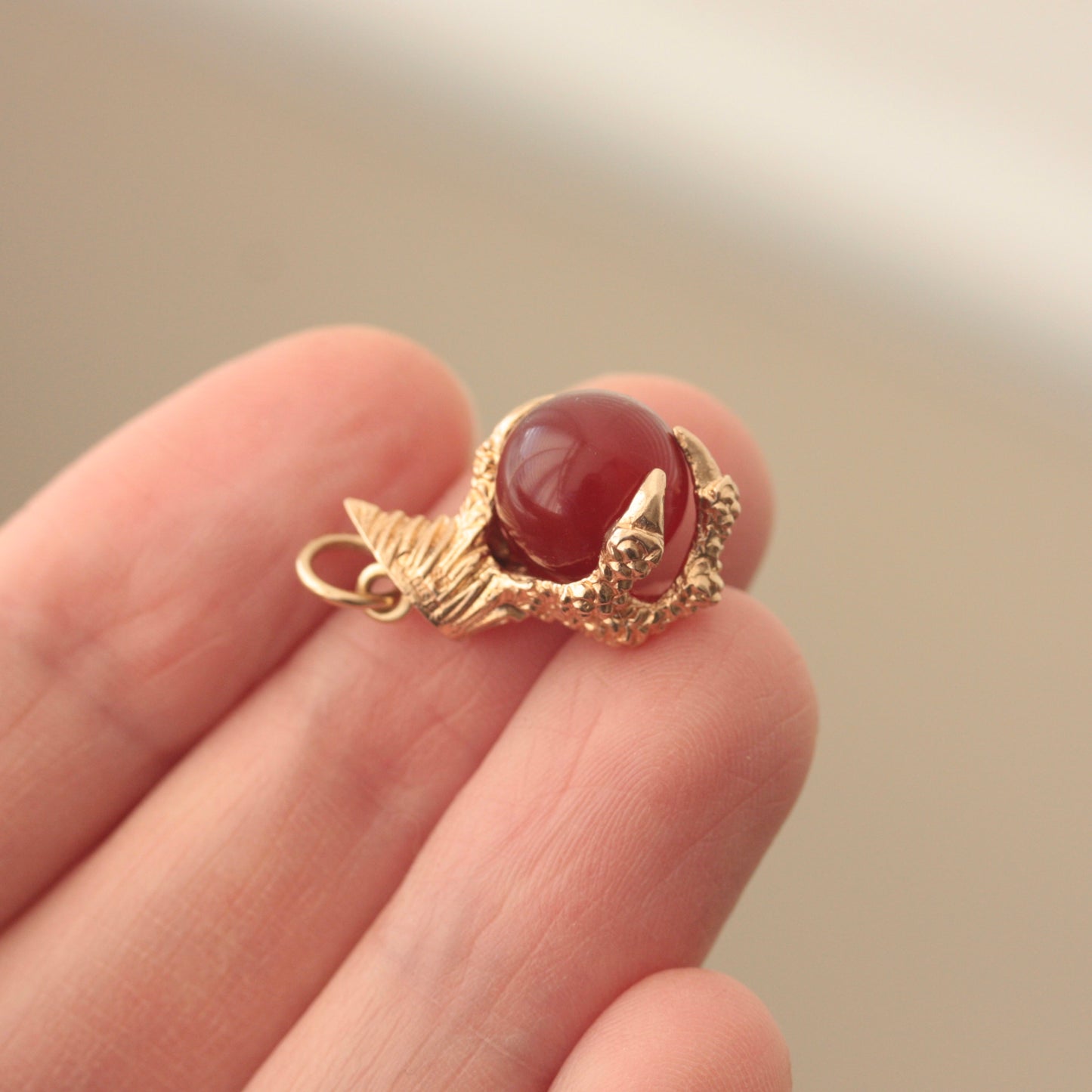 Vintage 1960s gold claw holding ball charm
